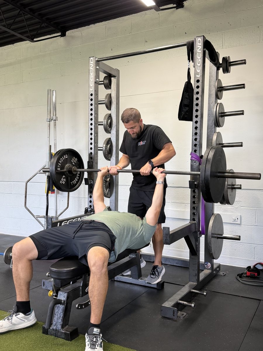 Carl spotting a member on the bench press