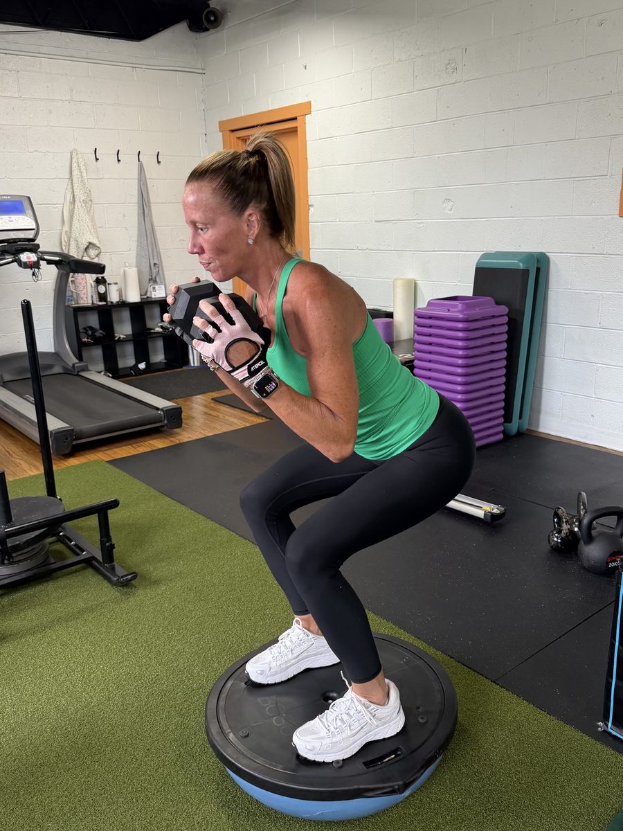 Bolt Fitness member doing a goblet squat on a balance trainer