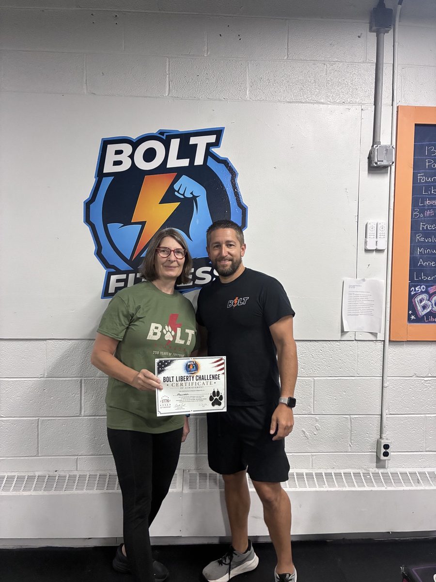 Bolt Fitness member receiving a Bolt Liberty Challenge certificate with Carl