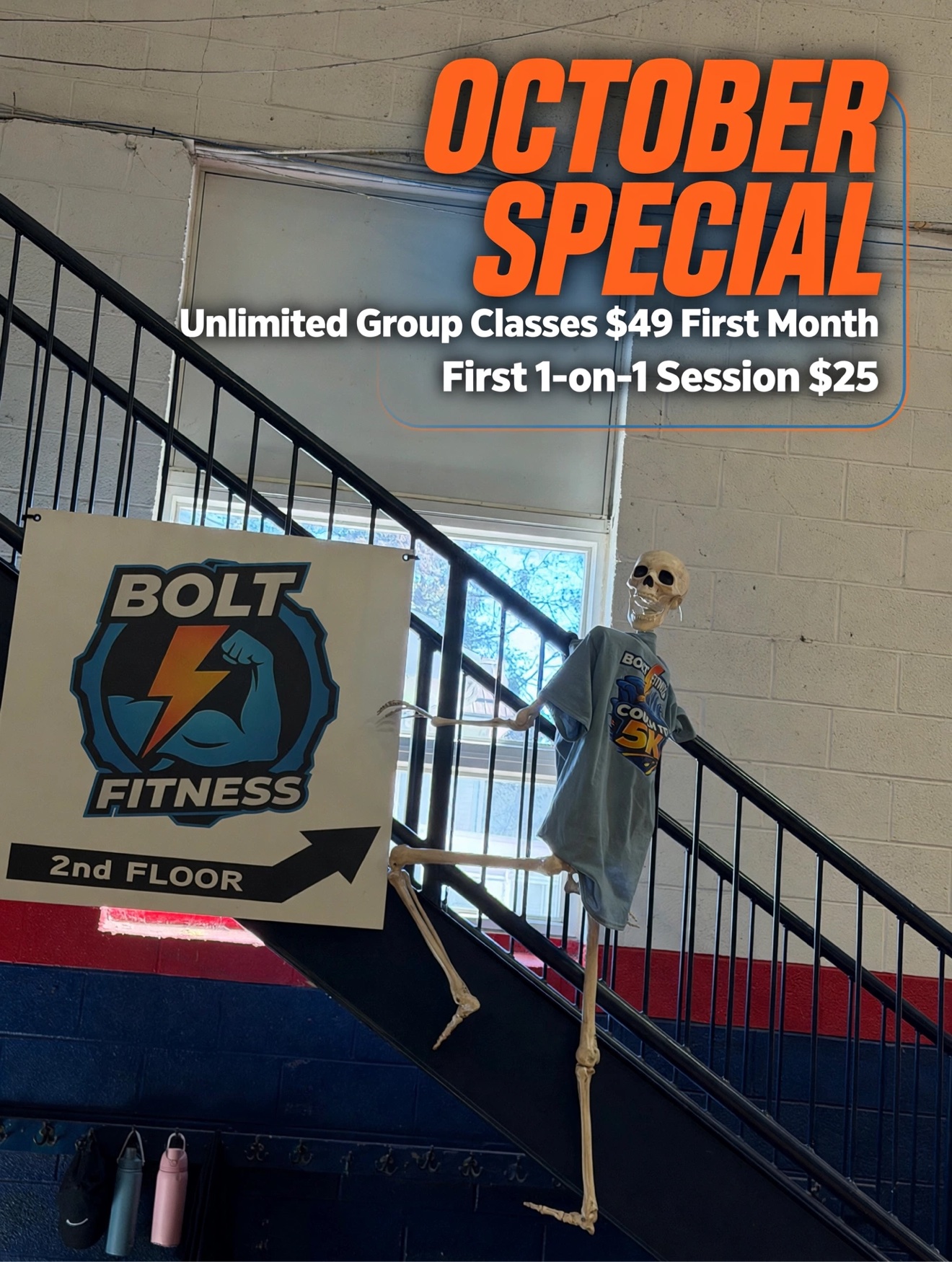 Bolt Fitness studio entrance with October Special details and a playful skeleton on the stairs